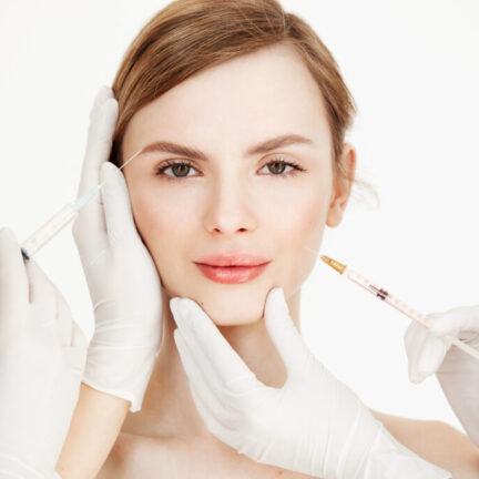 Cosmetologists hands making medical botox injections to beautiful blonde. Skin lifting. Facial treatment. Beauty and spa. Copy space.
